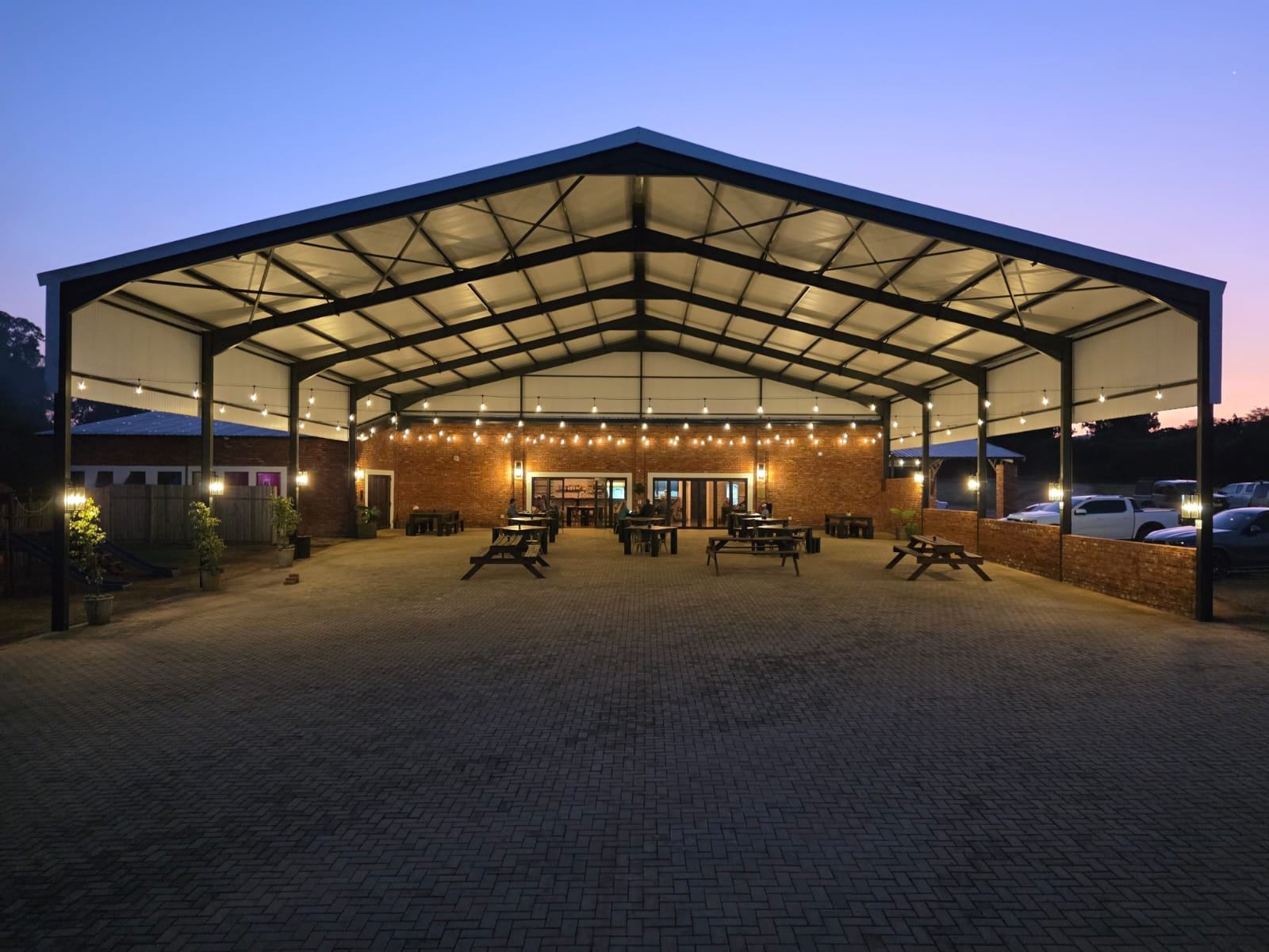 The covered pavilion at Vijgeboomsdrift lit up at dusk