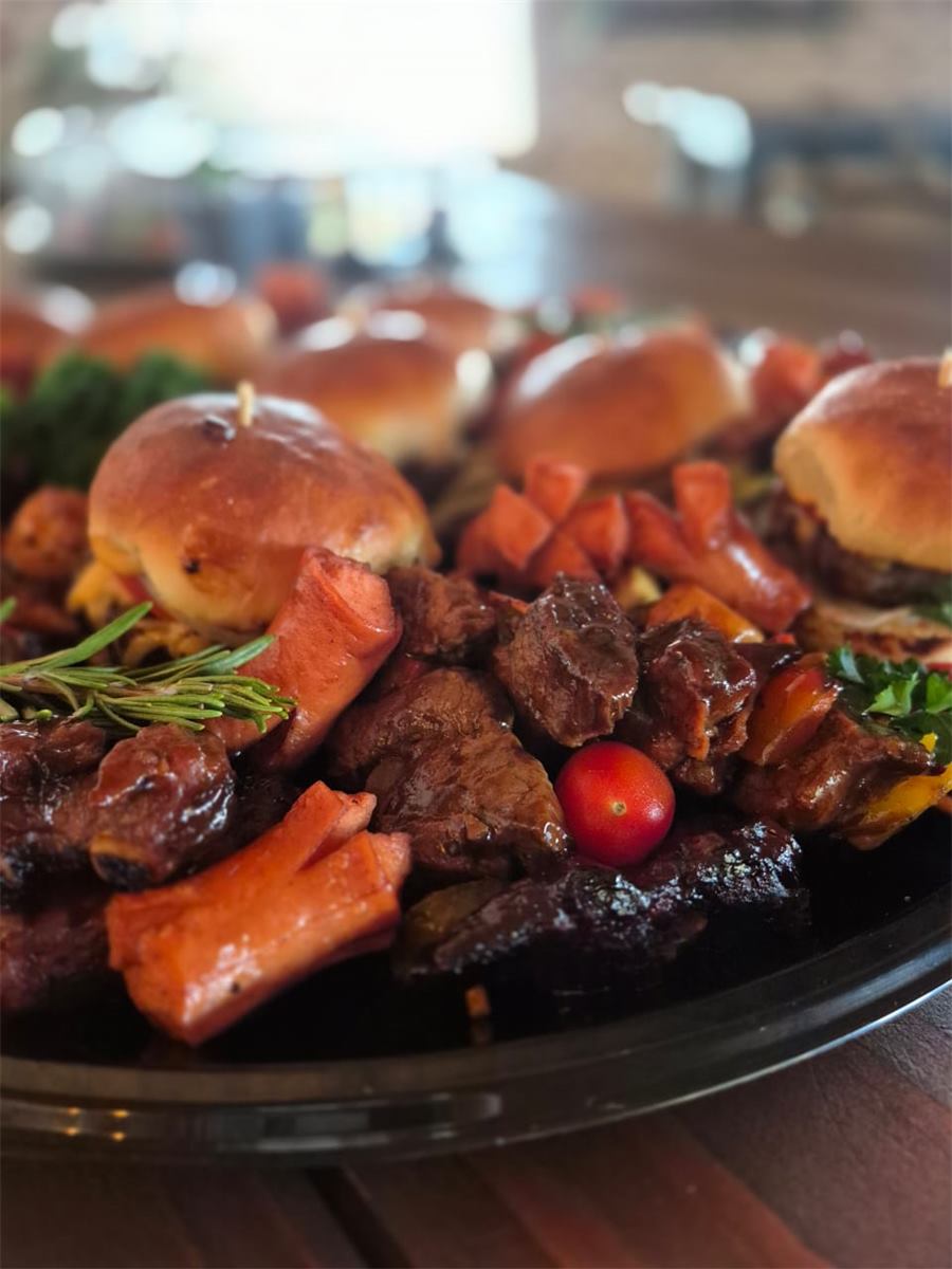 A platter of sliders, kebabs and sausage